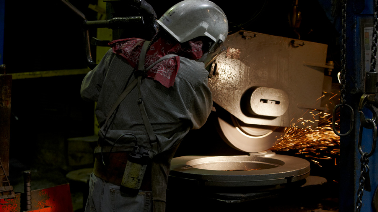 An employee works diligently on an iron casting at Prospect Foundry, an iron foundry in Minneapolis, Minnesota.